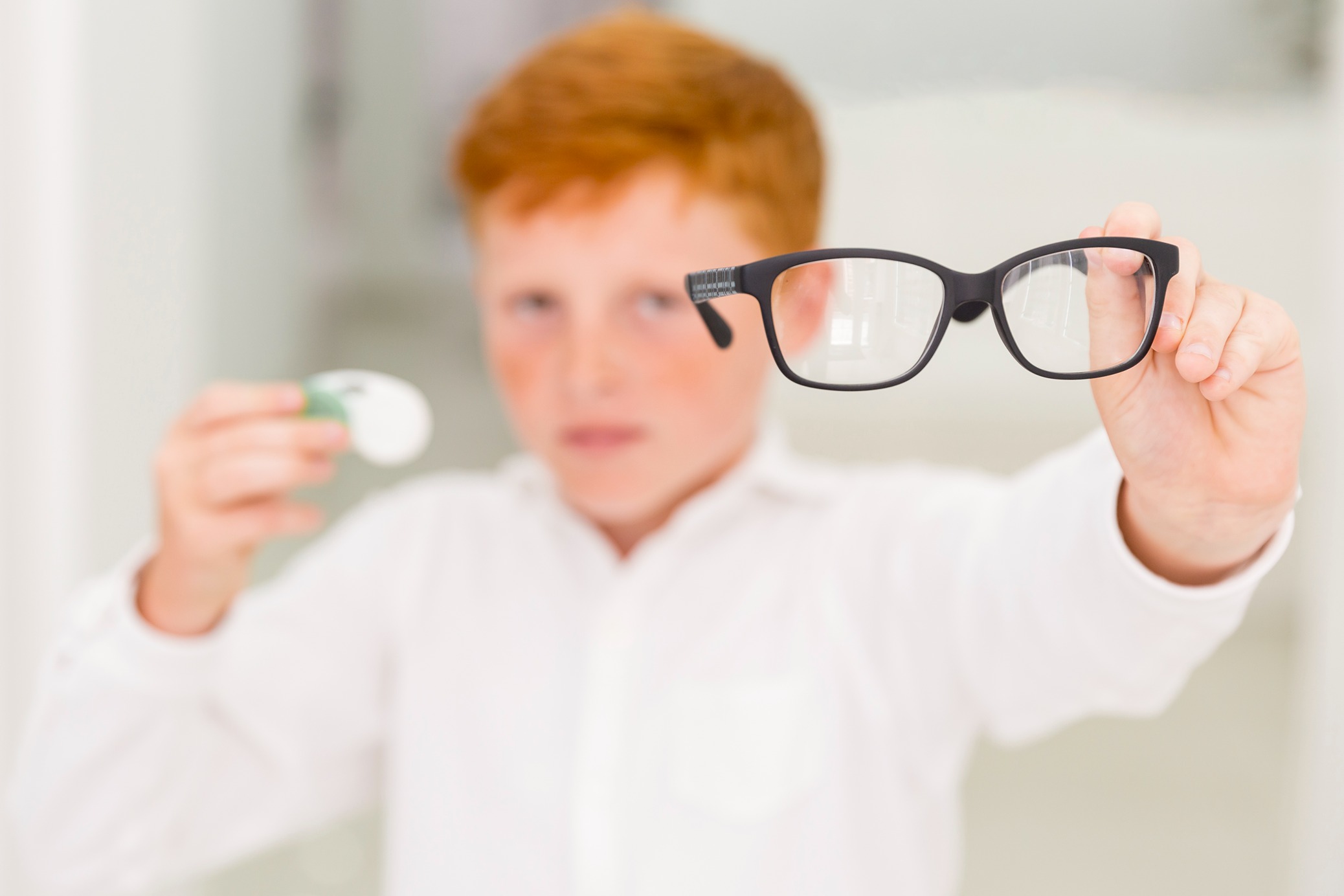 close-up-boy-showing-black-frame-eyeglasses