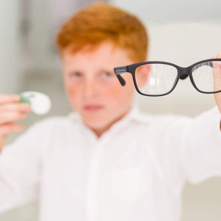 close-up-boy-showing-black-frame-eyeglasses